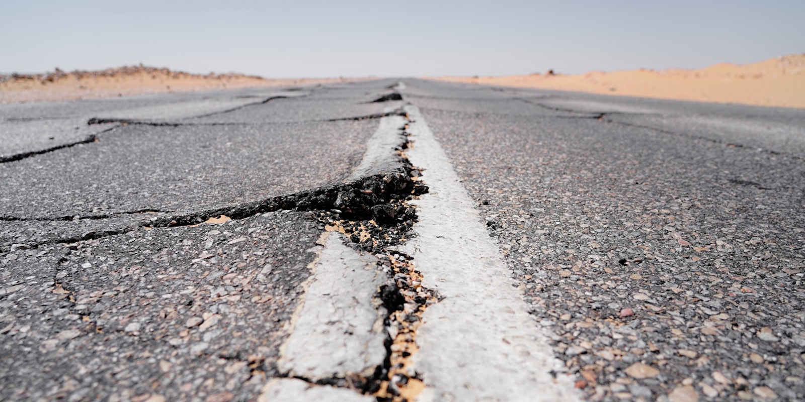 a crack in the middle of a road in the middle of nowhere, earthquake